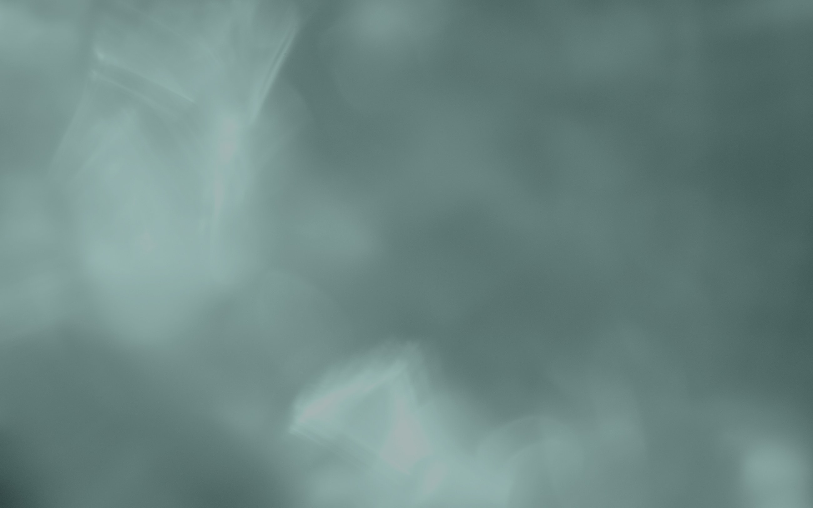Abstract teal background with soft textures.
