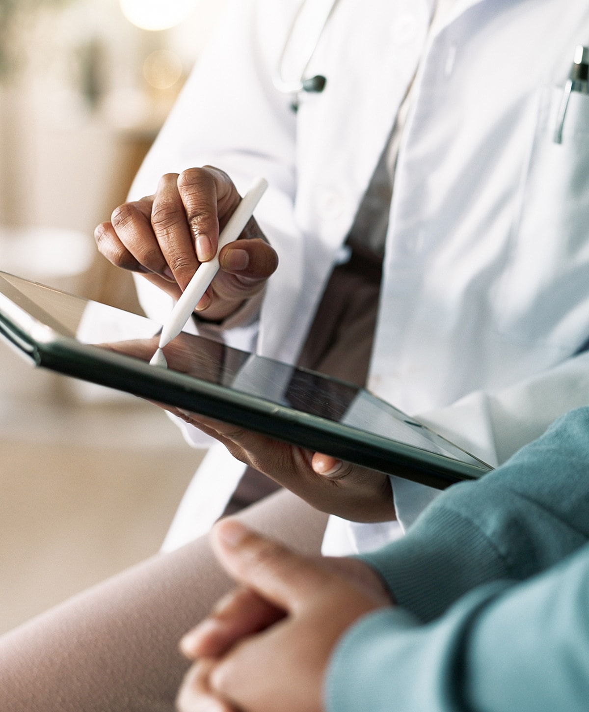 Laboratory technician holding test tubes in rack.