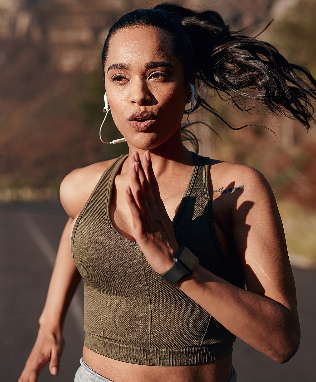 Person meditating by the sea at sunset.