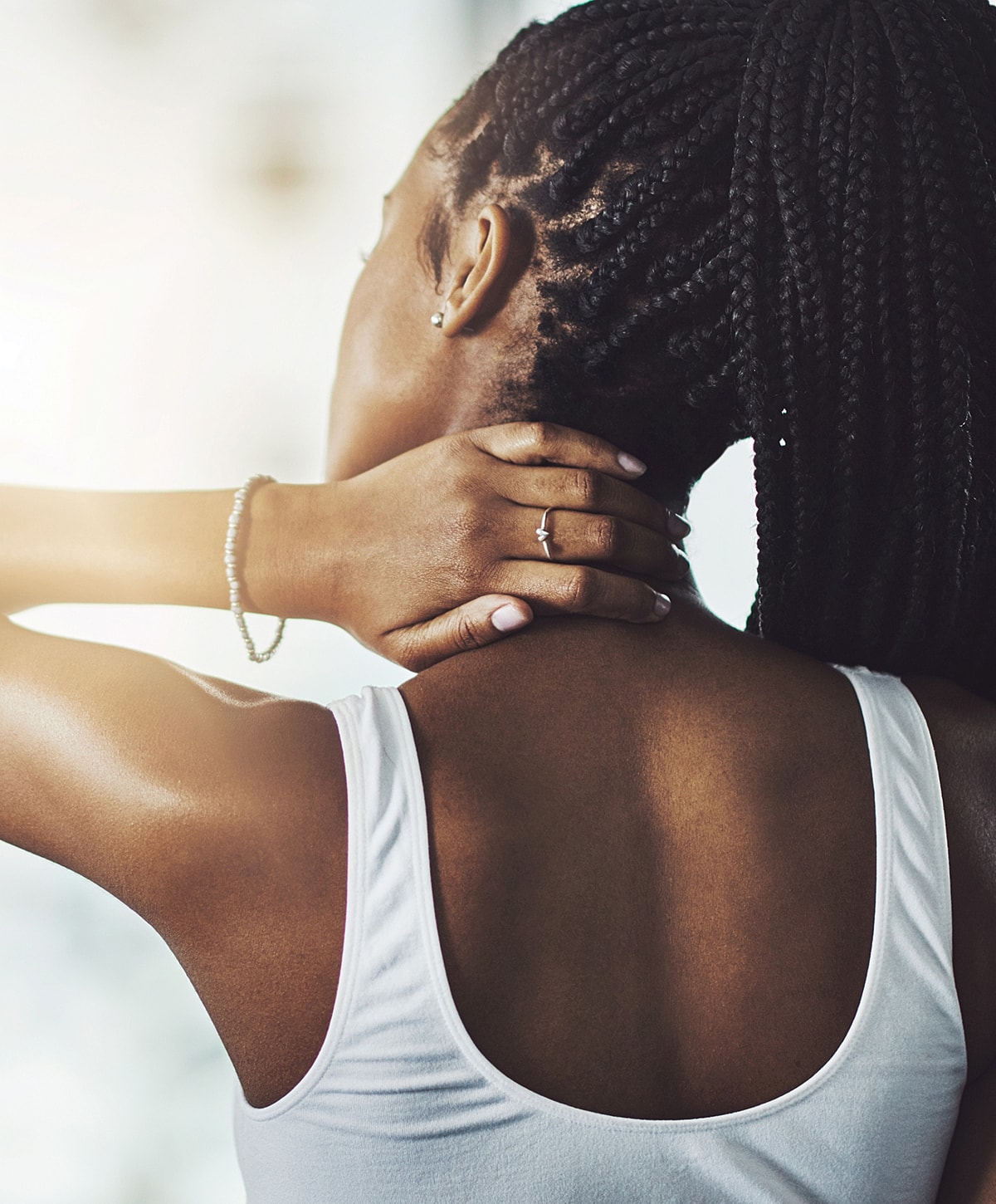 Laboratory technician holding test tubes in rack.