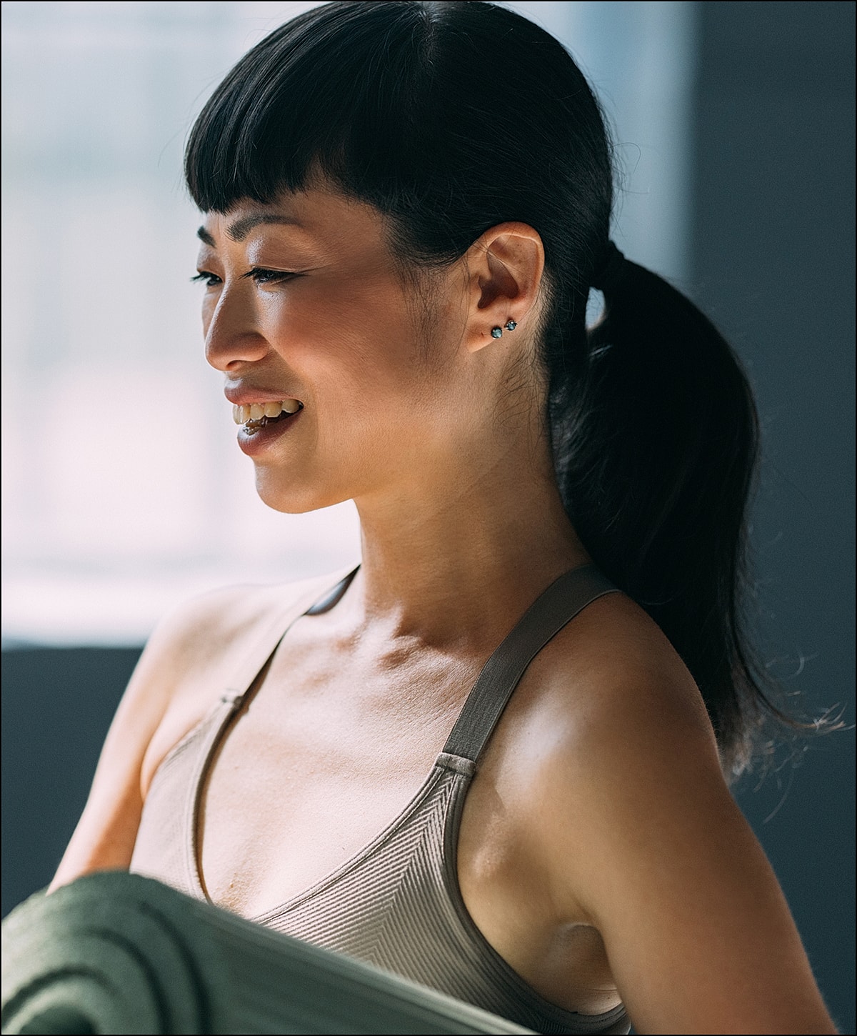 Person meditating by the sea at sunset.