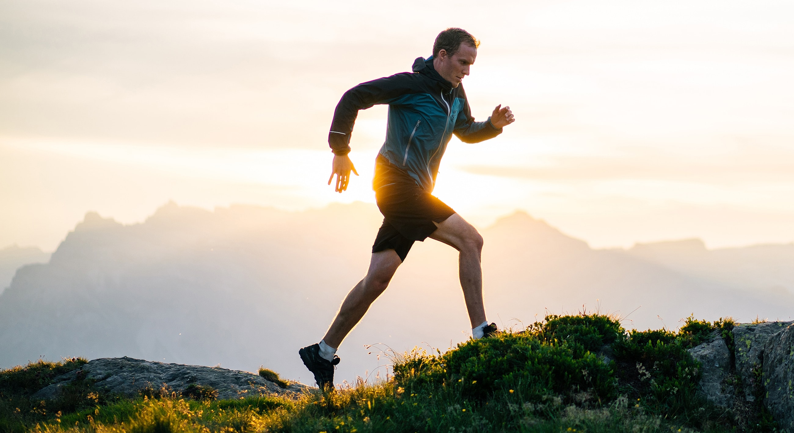 Man running in nature during sunset.